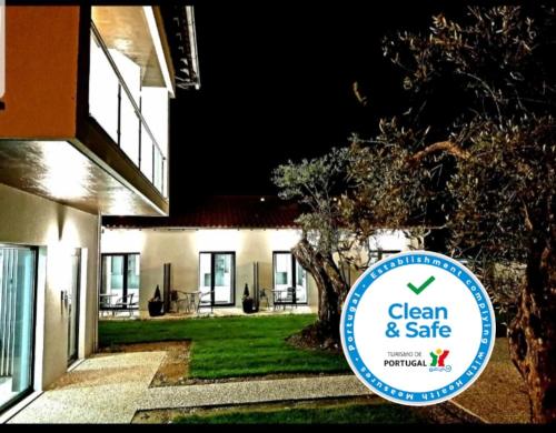 a sign for a clean and safe house at night at O Abel Hotel rural in Bragança