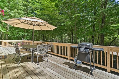 a grill and a table with an umbrella on a deck at Game Room and Golf Cart Bear Den Pocono Lake Home in Pocono Lake