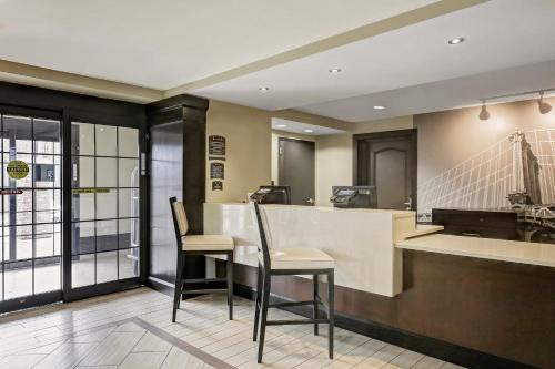 a lobby with a bar with two stools at Staybridge Suites Washington D.C. - Greenbelt by IHG in Lanham