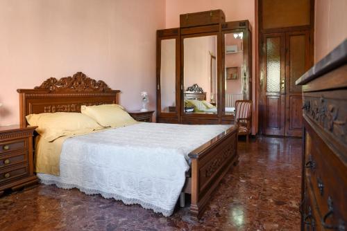 a bedroom with a bed and a large mirror at Olimpia B&B in Iglesias