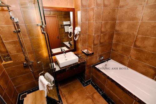 a bathroom with a tub and a sink and a bath tub at Khách sạn Phương Anh in HÆ°ng YÃªn