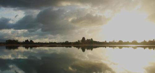 a large body of water with a cloudy sky at The Birch Tree B&B in Motueka