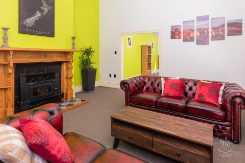 a living room with a couch and a fireplace at Waitomo Homestead Cabins in Waitomo Caves