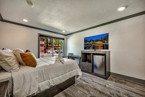 a bedroom with a large bed and a tv at The Elet Hotel in South Lake Tahoe