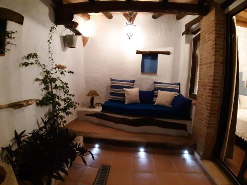 a living room with a blue couch in a room at Albaga in Sant Jordi