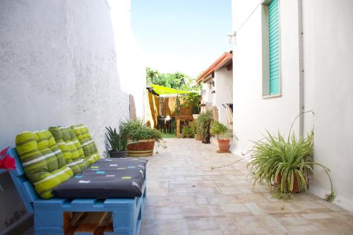 a blue couch sitting on a patio with plants at BnB Le Janas in Càbras