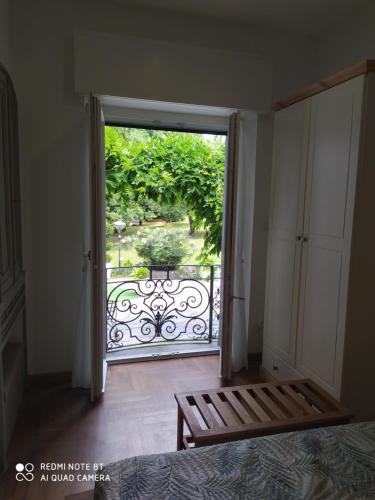 a bedroom with a door open to a balcony at "La Selvetta" bed and breakfast in Buguggiate
