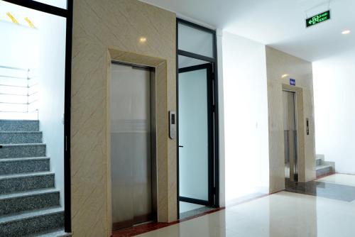 a hallway with doors and stairs in a building at Buon Ma Thuot Hotel in Buon Ma Thuot