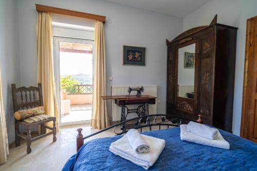 a bedroom with a bed and a mirror and a table at Dryades Villa in Arménoi