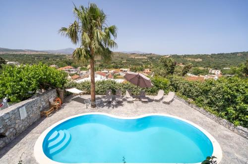a swimming pool with a view of a villa at Dryades Villa in Arménoi