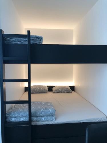 a bunk bed with two pillows on the bottom bunk at FLORIDE in Knokke-Heist