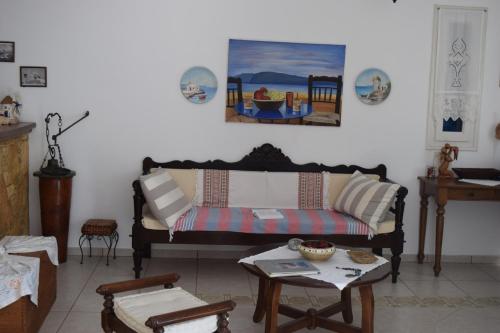 a living room with a couch and a table at Paraporti in Chora Folegandros