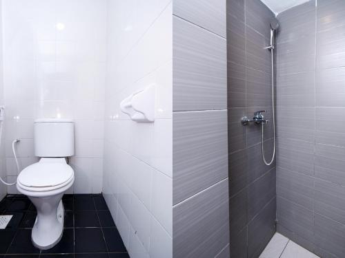 a bathroom with a toilet and a shower at SPOT ON 89838 Lm Residence in Miri