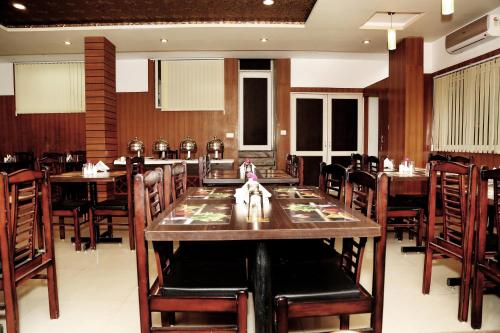 a dining room with wooden tables and chairs at Narayans Leela Inn in Udaipur