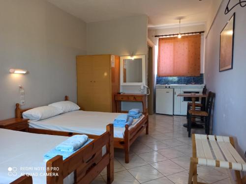 a small room with two beds and a kitchen at Vias in Neapolis