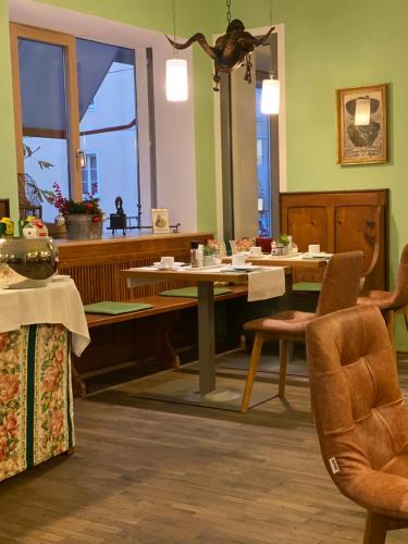 a living room filled with furniture and a chair at Bergland Hotel - Adults only in Salzburg