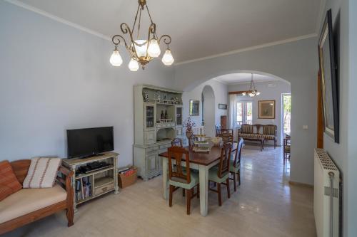 a living room with a table and a dining room at Dryades Villa in Arménoi