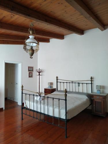a bedroom with a bed and a wooden ceiling at Liknon Guesthouse Villa in Galaxidi