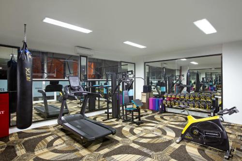 a gym with bikes and exercise equipment in a room at The Alana Hotel & Conference Center Malioboro Yogyakarta by ASTON in Yogyakarta