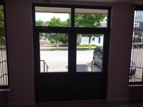 a door with a view of a parking lot at Hotel Hobby in Hunedoara