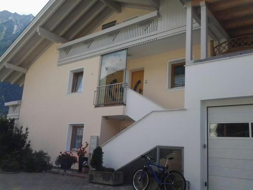 a blue bike parked in front of a house at Haus Martina in Sand in Taufers