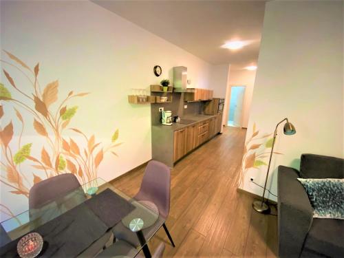 a living room with a glass table and chairs at Chopok Juh - Ambiente Apartment in Tale