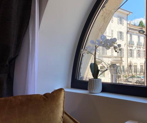a window with a vase with flowers on a window sill at Le Royal 4 - Apartment for 4 people in the city center in Annecy