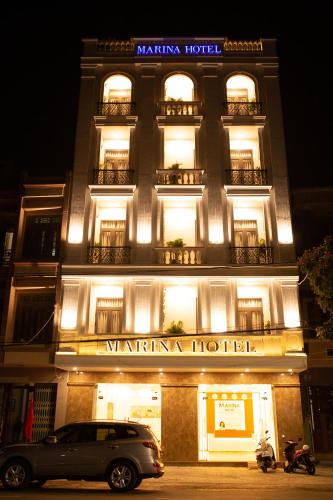 a building with a car parked in front of it at Marina Hotel Phú Yên in Tuy Hoa