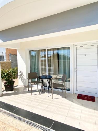 a patio with a table and chairs on a house at Livia’s Appartments in Paphos