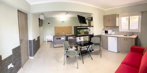 a kitchen and a living room with a table and chairs at Livia’s Appartments in Paphos City