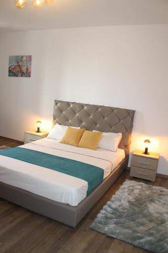 a bedroom with a large bed with two night stands at STUDIO TURQUOISE Victoria in Bucharest