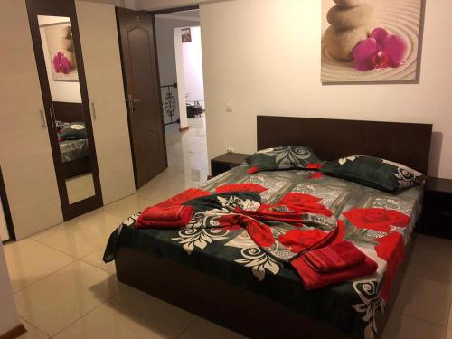 a bedroom with a bed with red towels on it at Amani & Melisa 2 in Eforie Nord