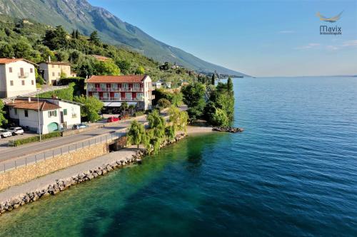 a town on the shore of a body of water at Hotel Al Molino in Malcesine