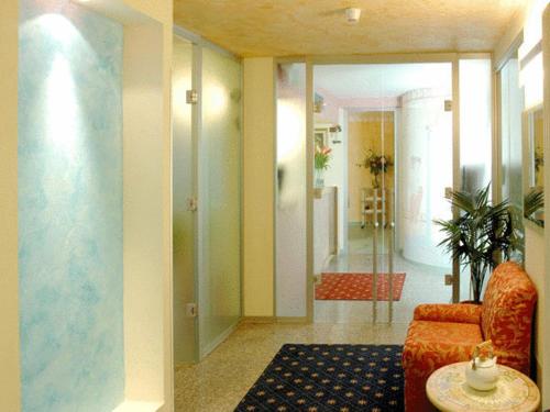 a lobby with a chair and a table and a hallway at Hotel Ferrari in Salsomaggiore Terme