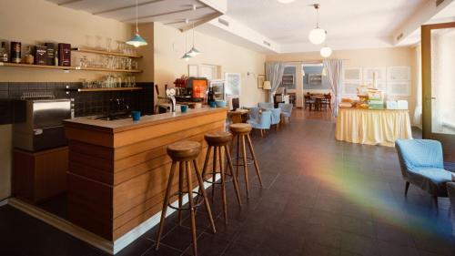 a kitchen with a bar with stools and a rainbow at Drauradweg Hostel in Berg im Drautal