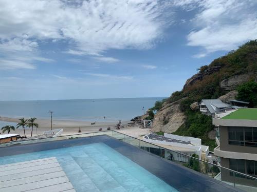 a swimming pool with a view of the beach at Santorini Khao Takiab Huahin Beach Front in Hua Hin