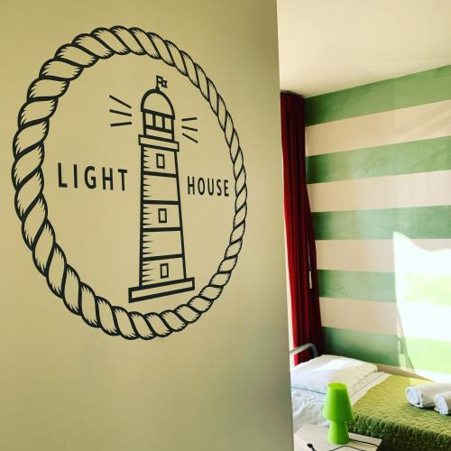a bedroom with a lighthouse sticker on the wall at The Lighthouse Rooms in Lazise