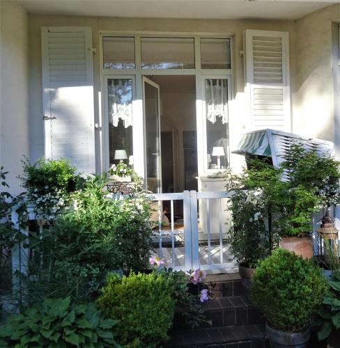 a front porch of a house with plants at Apartments Villa Seeblick Travemünde in Travemünde