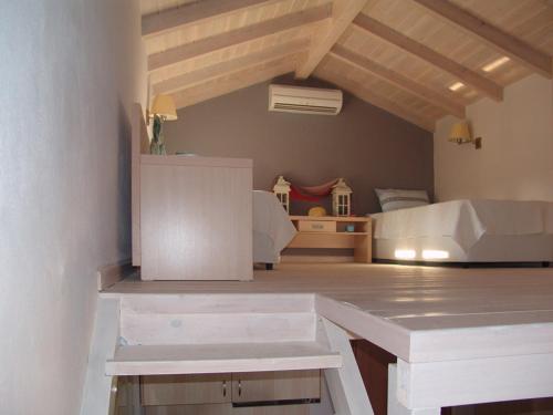 a bedroom with a bed and a desk in a room at Enalia Gi in Limne