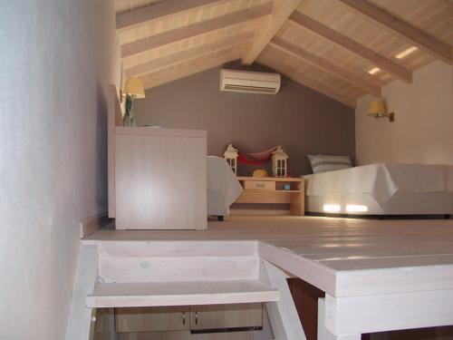 a bedroom with a bed and a desk in a room at Enalia Gi in Límni