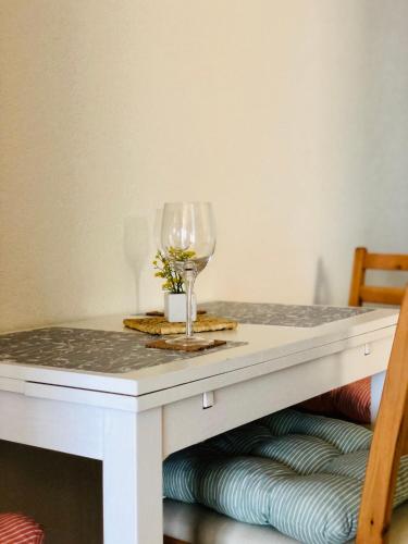 a white table with a glass of wine on it at Guest House Stipe in Brela