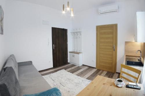 a living room with a couch and a table at Willa Zator in Oświęcim