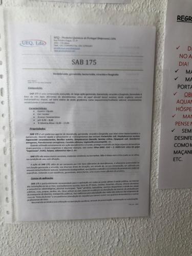 a piece of paper sitting on the wall at Fonte da Telha Beach Hostel in Costa da Caparica
