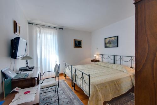 a bedroom with a bed and a television in it at Villa Tuttorotto in Rovinj