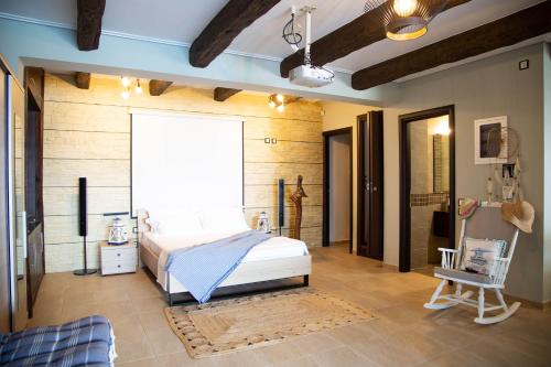 a bedroom with a bed and a chair in a room at NIAN villa sea in Drosia