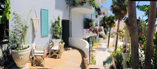 a balcony with chairs and plants on a building at Illyrian Boutique Hotel in Sarandë