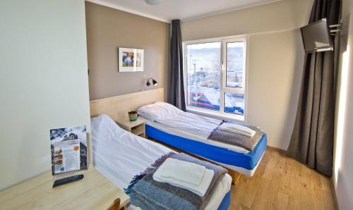 Tempat tidur dalam kamar di Lillehammer Stasjonen Hotel
