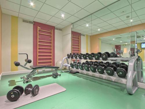 a gym with a rack of dumbbells in a room at Mercure Paris Velizy in Vélizy-Villacoublay