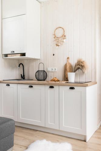 a kitchen with white cabinets and a counter top at ZATORHOUSE in Zator