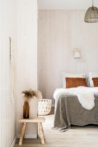 a white bedroom with a bed and a table at ZATORHOUSE in Zator